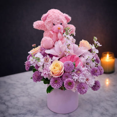 Flower box with pink teddy bear - purple chrysanthemums, peach roses and pink lily in a round pink velvet box