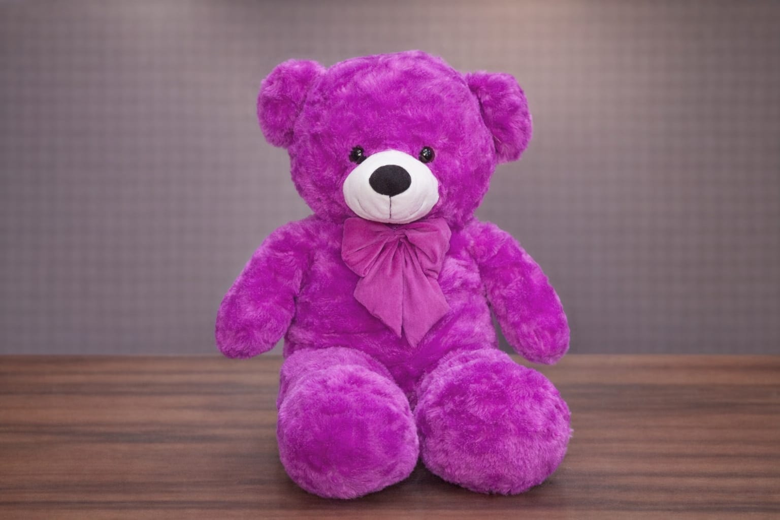 Giant vibrant purple plush teddy bear 1 meter tall with white muzzle and purple bow tie